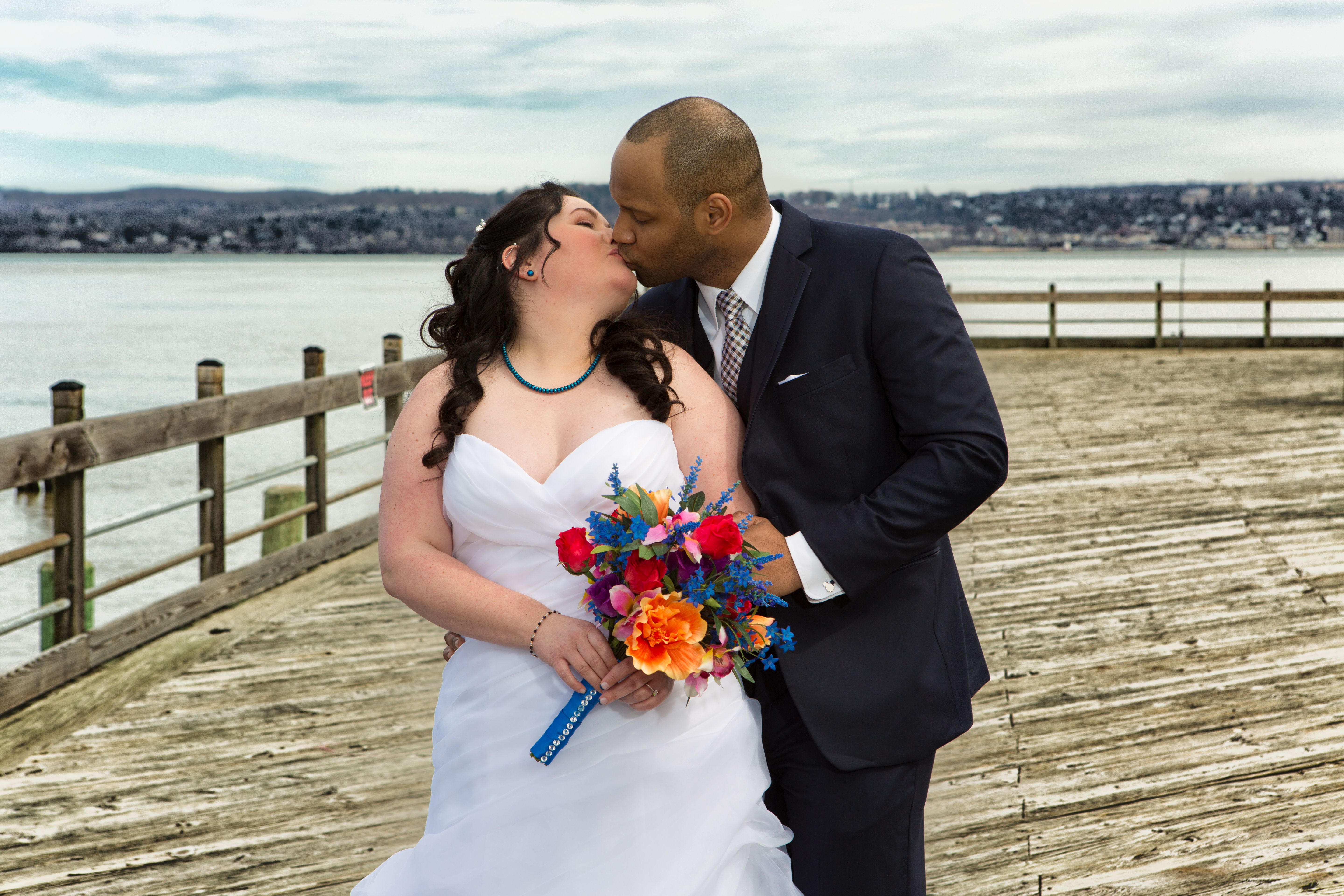 With Beautiful Spring Flowers in Hand, NY Bride Poses With Groom For Stunning Wedding Photos On the Water- The Nyack Seaport in Nyack, NY