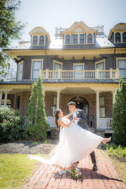 With Spring Blooming Around Them, NJ Groom Dips His Stunning Bride in Front of Beautiful Historic Home- The Oakside Mansion in Bloomfield, NJ